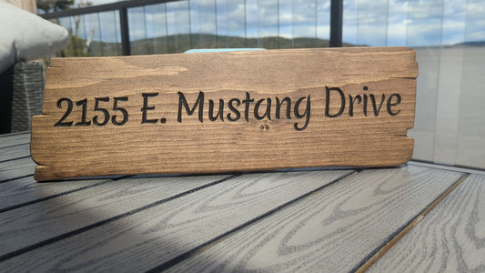Close-up video of engraved wood address plaque for '2155 E. Mustang Drive', highlighting high visibility and custom engraving detail.